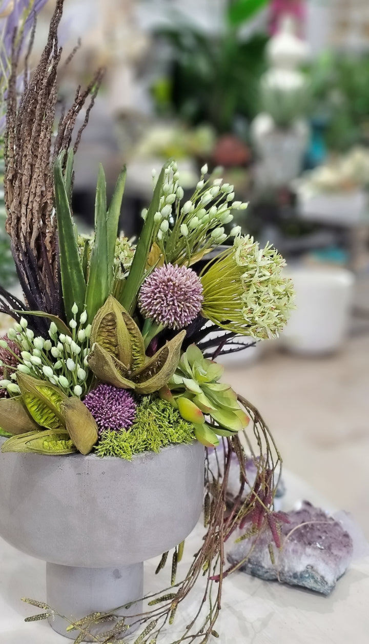 Allium, Agapanthus, Aloe, Succulents, Sora Pods, Hanging Vine, and Coco Jhar in Bowl. FH: 31"H